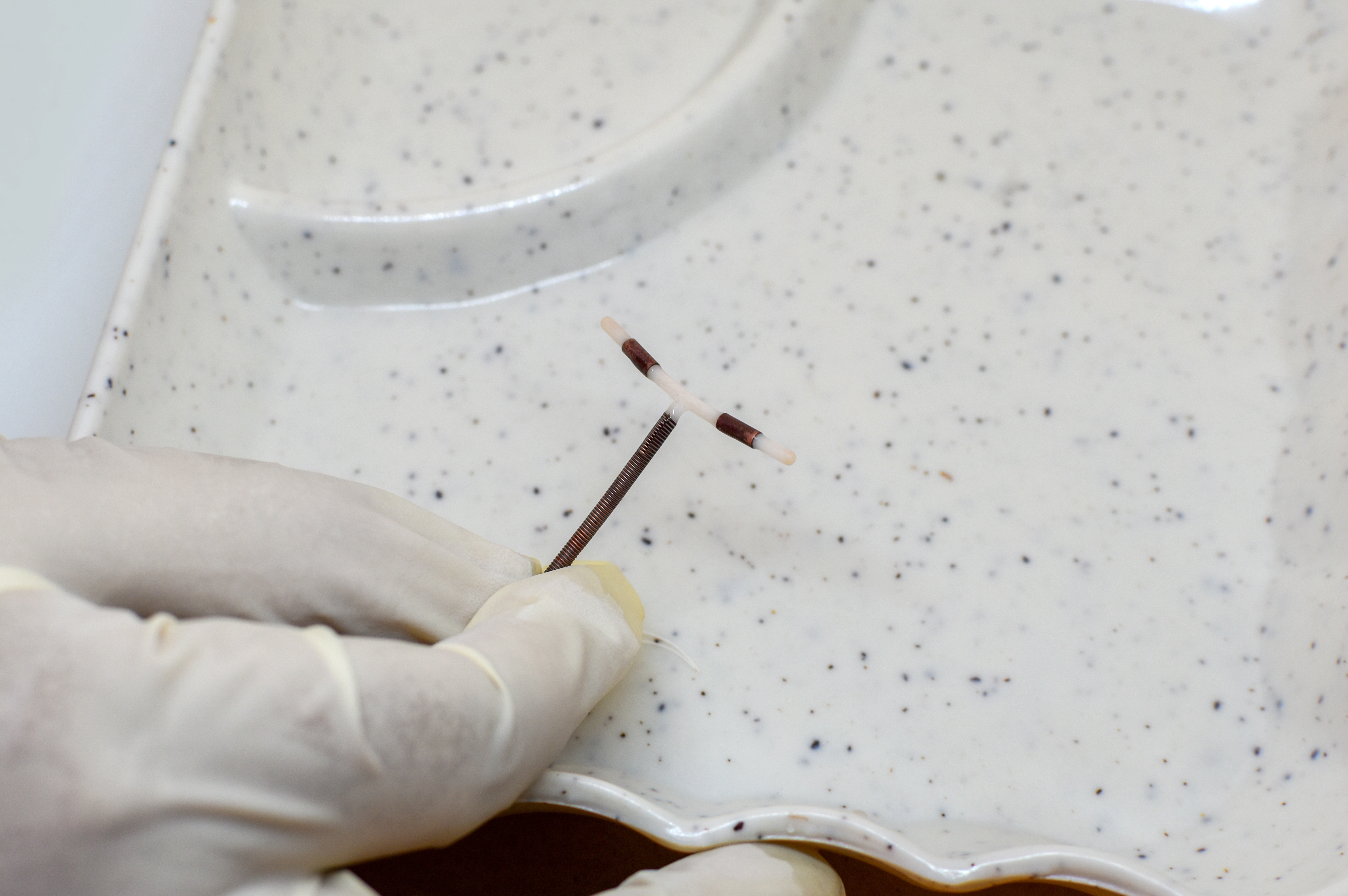 Doctor,Holding,A,T-shaped,Intrauterine,Birth,Control,Device,On,The